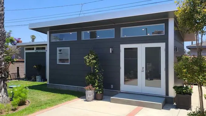 Modern single-story gray house with large windows featured in Finance News.
Modern single-story gray house with large windows featured in Finance News.
