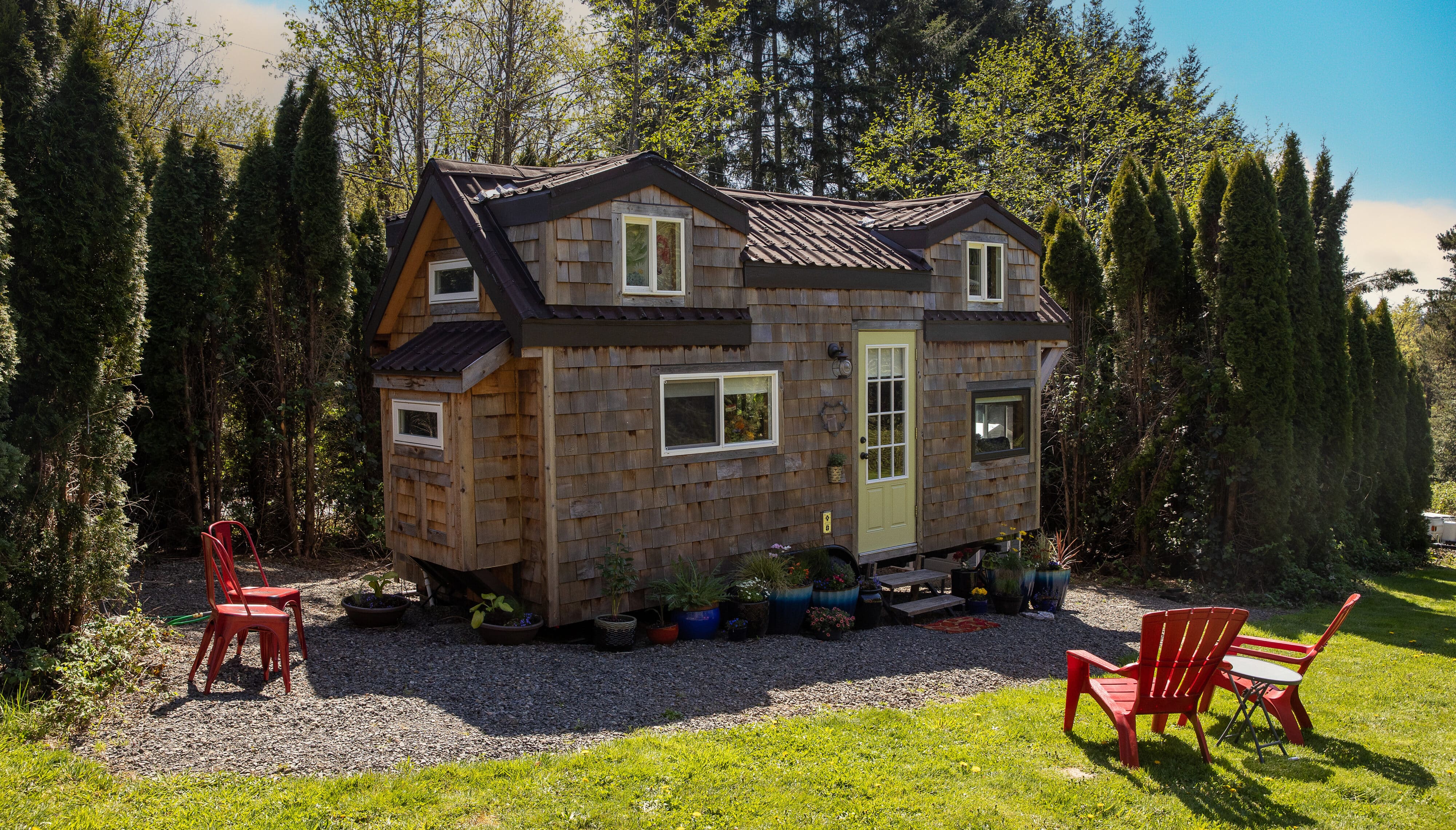 A small, rustic tiny house with affordable cost and colorful accents.